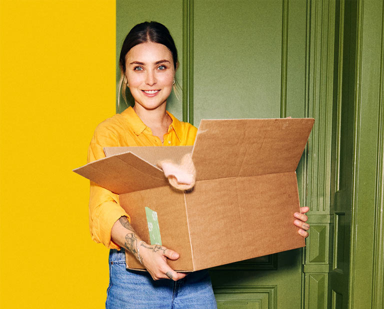 Young woman with her moving box